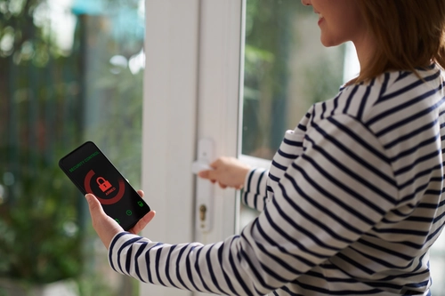 woman setting home security system