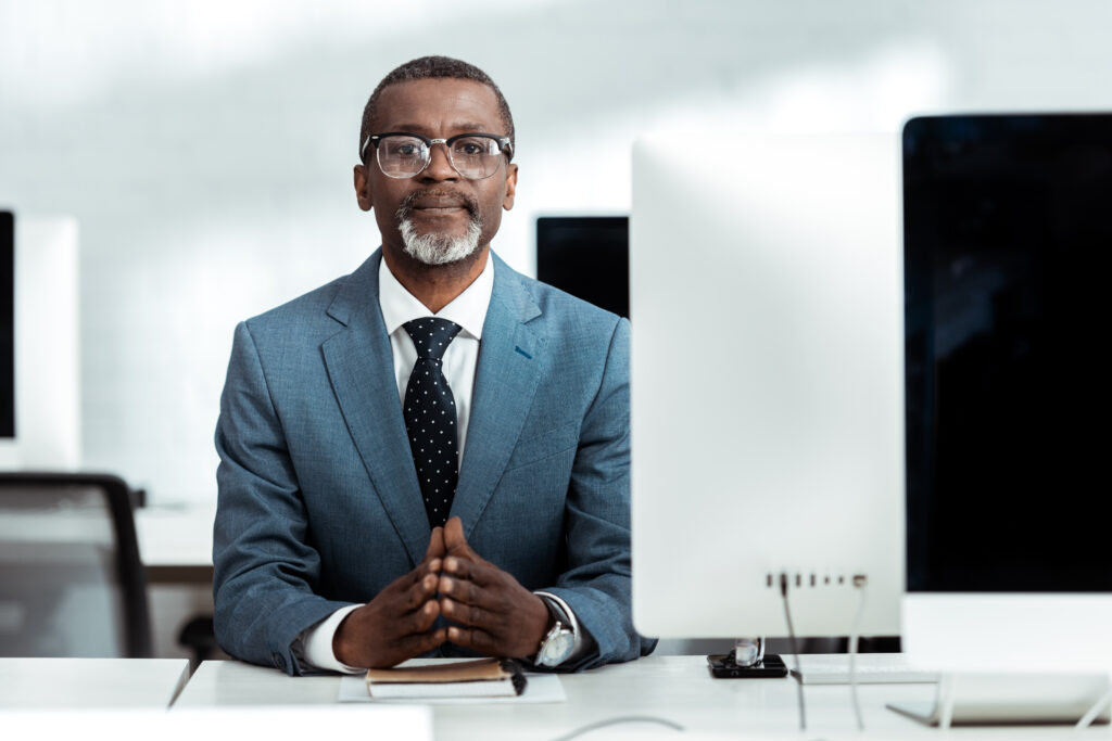 Successful African American Businessman With Clenched Hands In Office - ADF PRO
