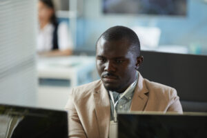 Focused Black Man Looking At Computer Screen - ADF PRO