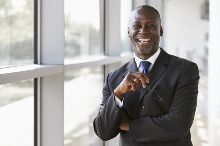Portrait Of A Smiling Businessman Holding Glasses - ADF PRO