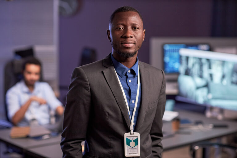 Black Businessman Wearing Suit While Standing In Office - ADF PRO